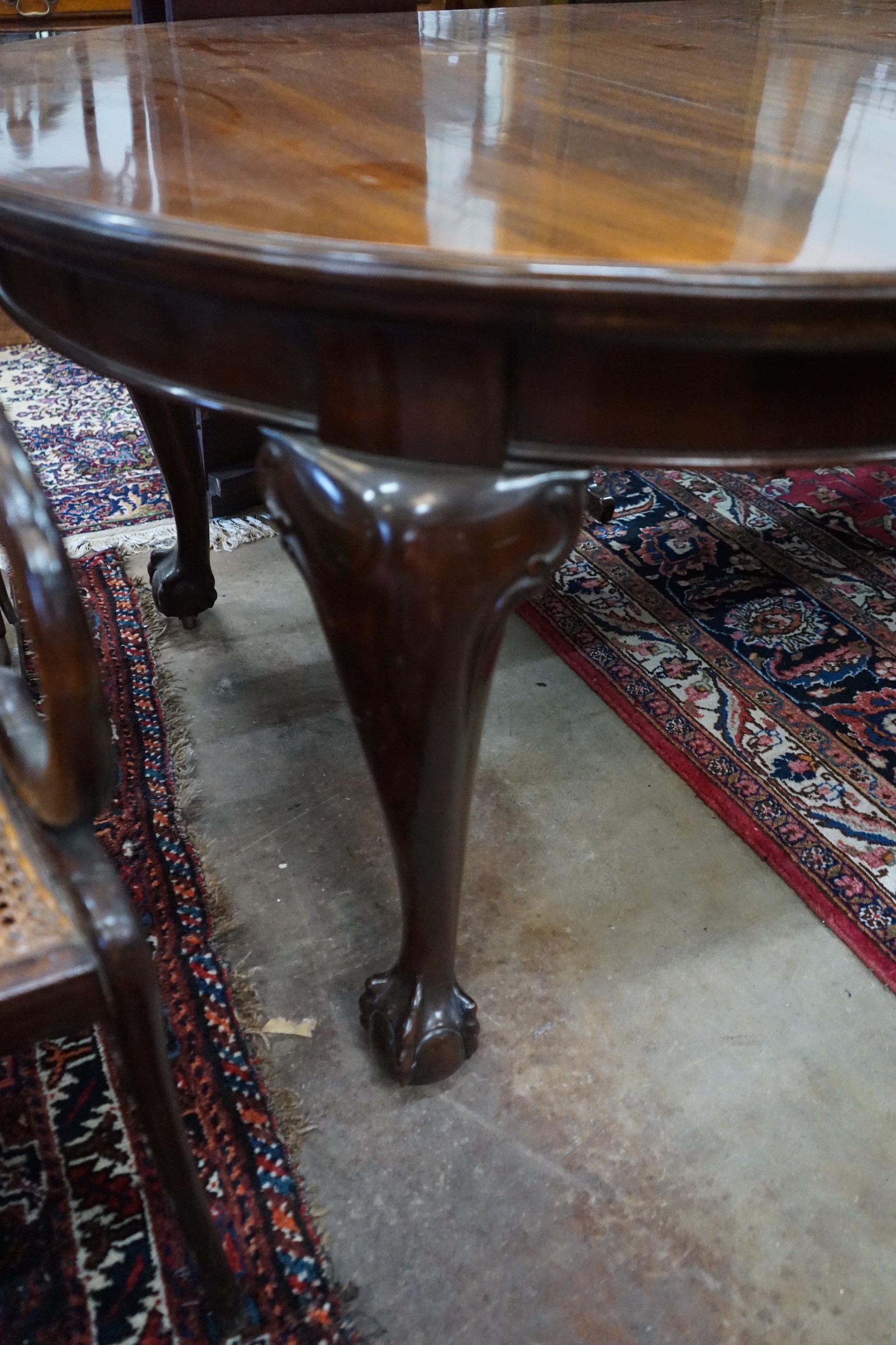 A 1920's mahogany extending dining table on ball and claw feet, with three spare leaves, 296cm extended, width 120cm, height 73cm